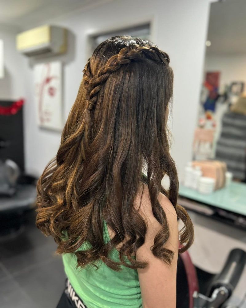A Woman Is Getting Her Hair Done In A Salon — Sarina Hair Fashions in Sarina, QLD