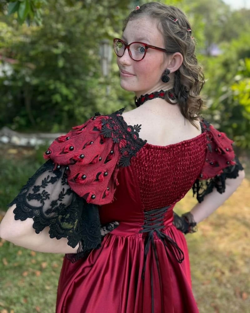 A Woman With Blonde Hair And Blue Streaks Is Wearing A Blue Shirt — Sarina Hair Fashions in Sarina, QLD