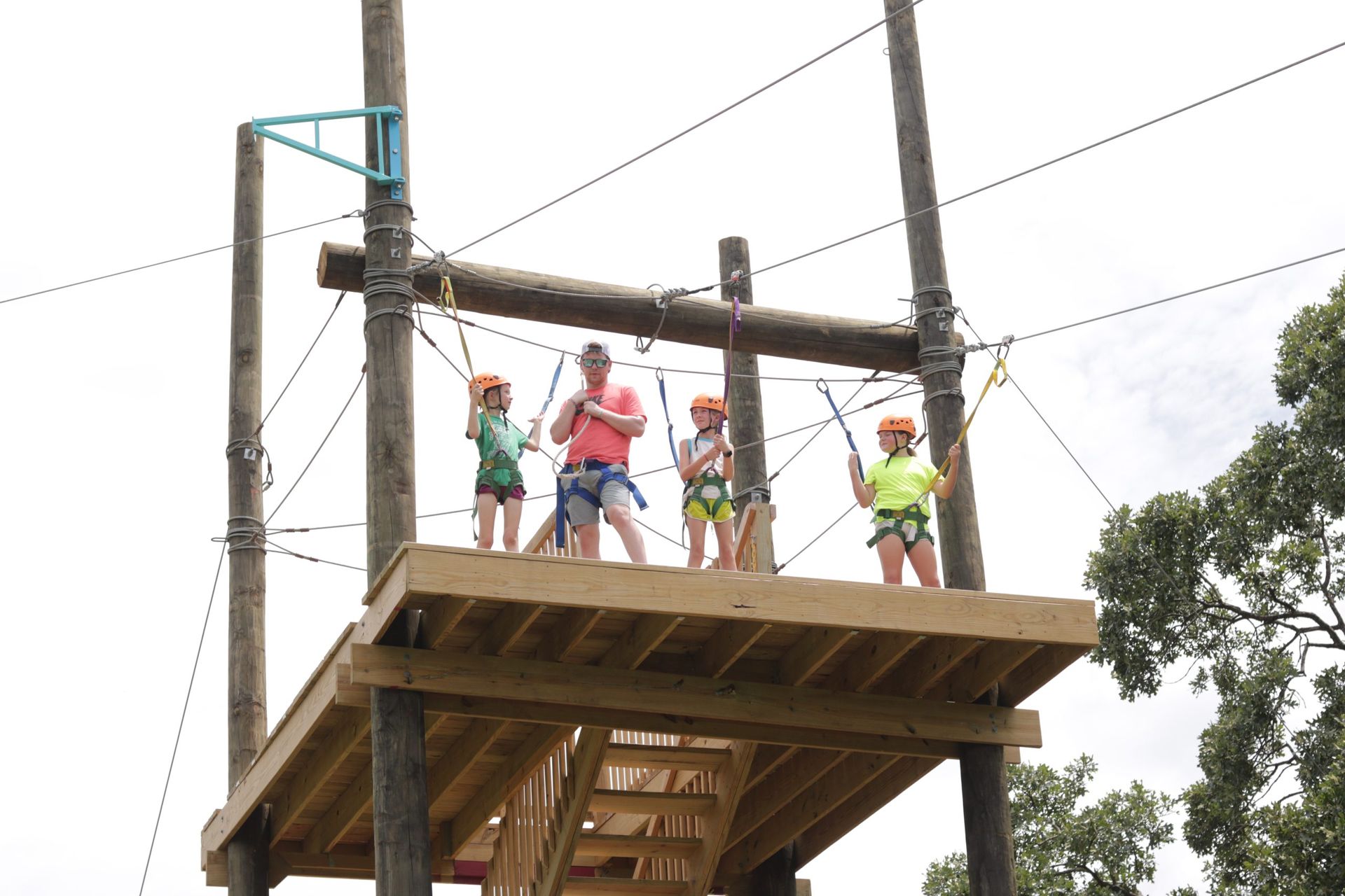 A group of people are standing on top of a wooden platform.