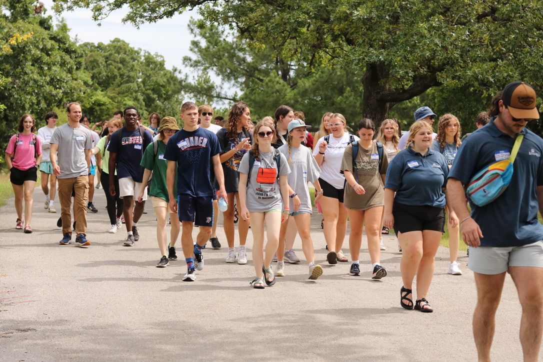 A group of people are walking down a street.