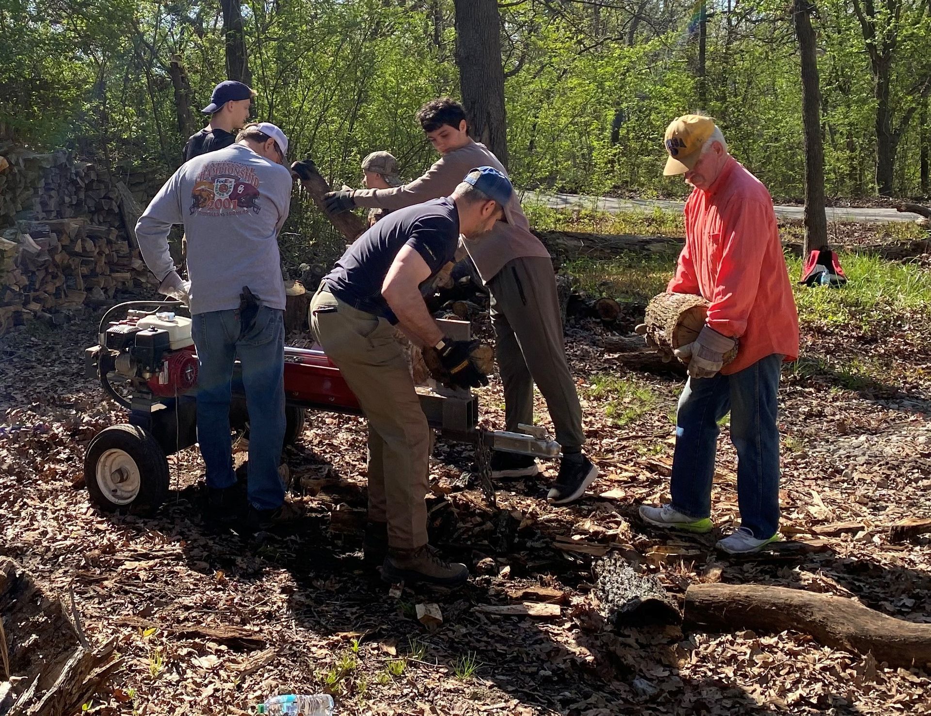 Volunteers splitting firewood