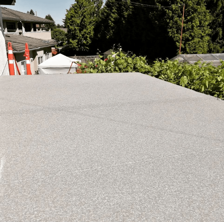 stone deck with fire pit outside a white exterior house