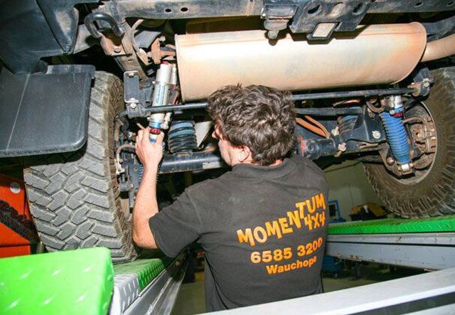 man repairing jeep