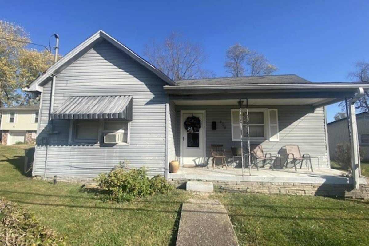 A house with gray siding and covered front porch near Lexington, KY