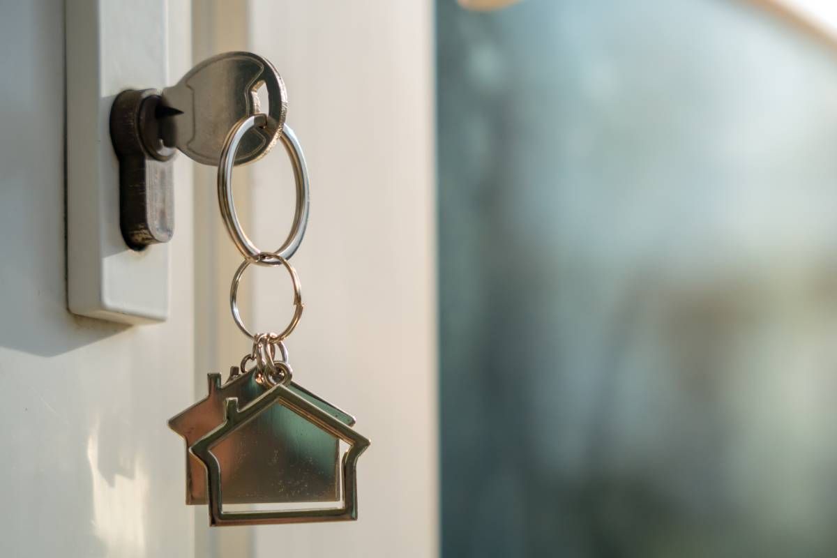 Key inside the front door of a home with a dangling keychain near Lexington, KY