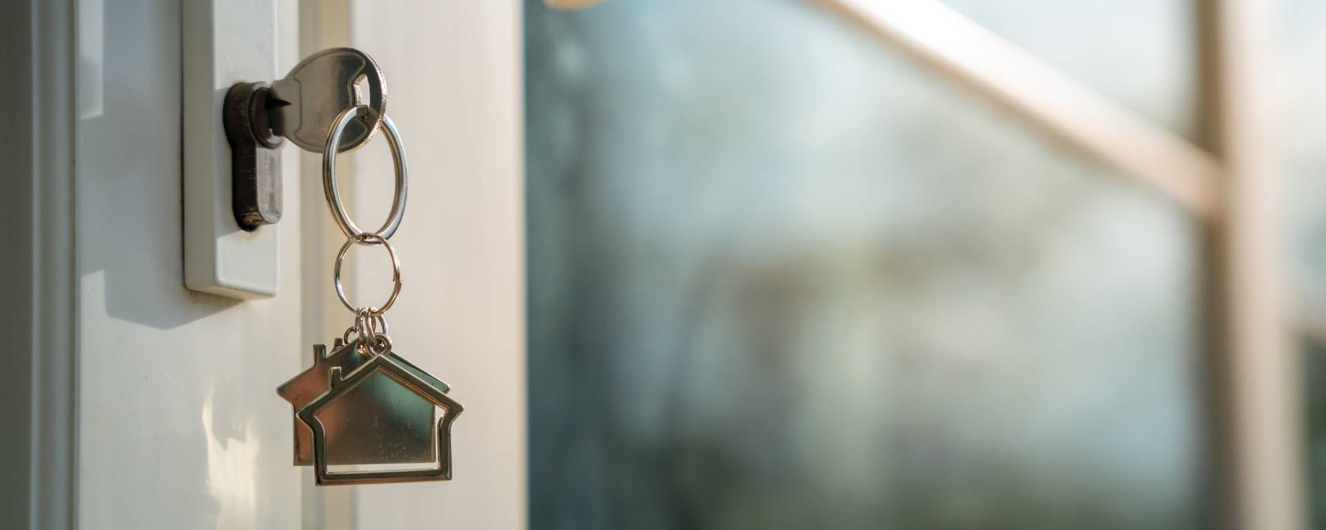 Key inside the front door of a home with a dangling keychain near Lexington, KY