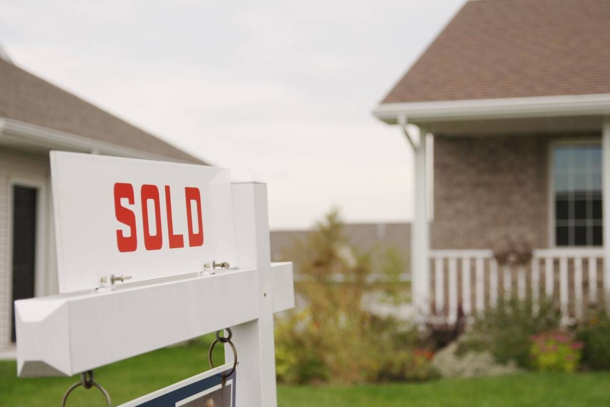 Sold sign in the front yard of a vacant home near Lexington, KY