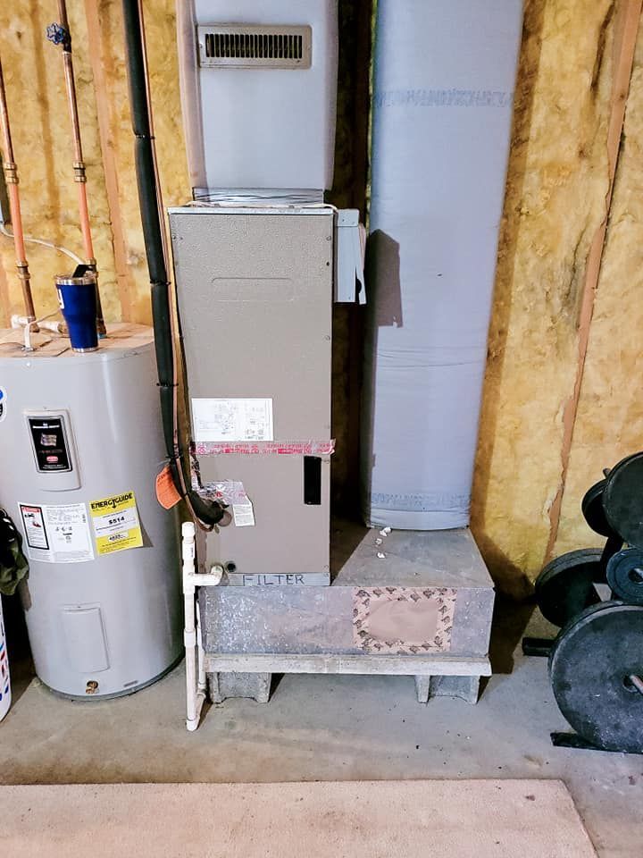 There is a water heater and an air conditioner in the basement.