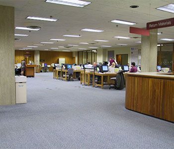 Library interior with computers, desks, and 