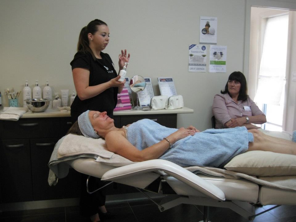 A woman in a towel is laying on a massage table