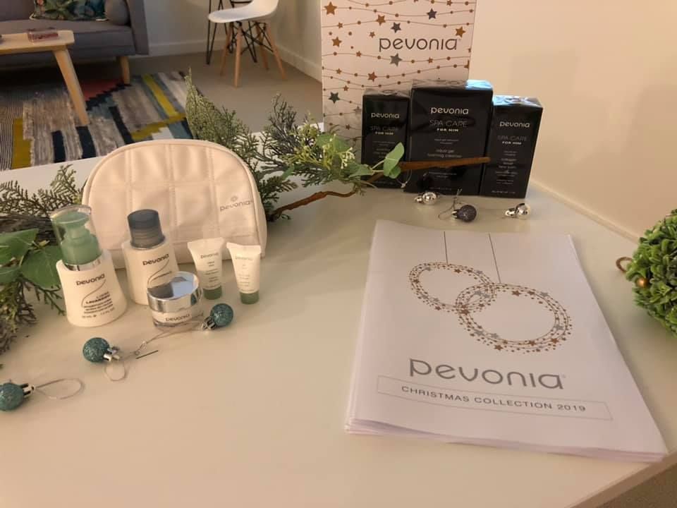 A table with a bag of cosmetics and a book on it.