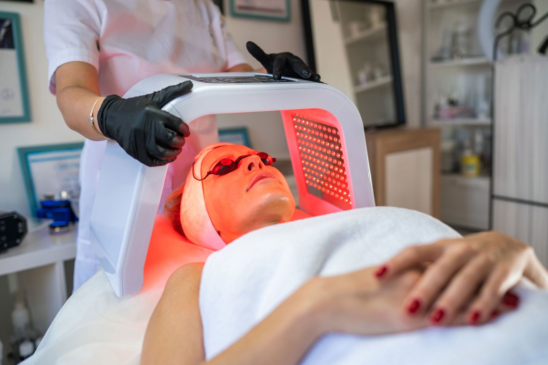 A woman is getting a facial treatment in a beauty salon.