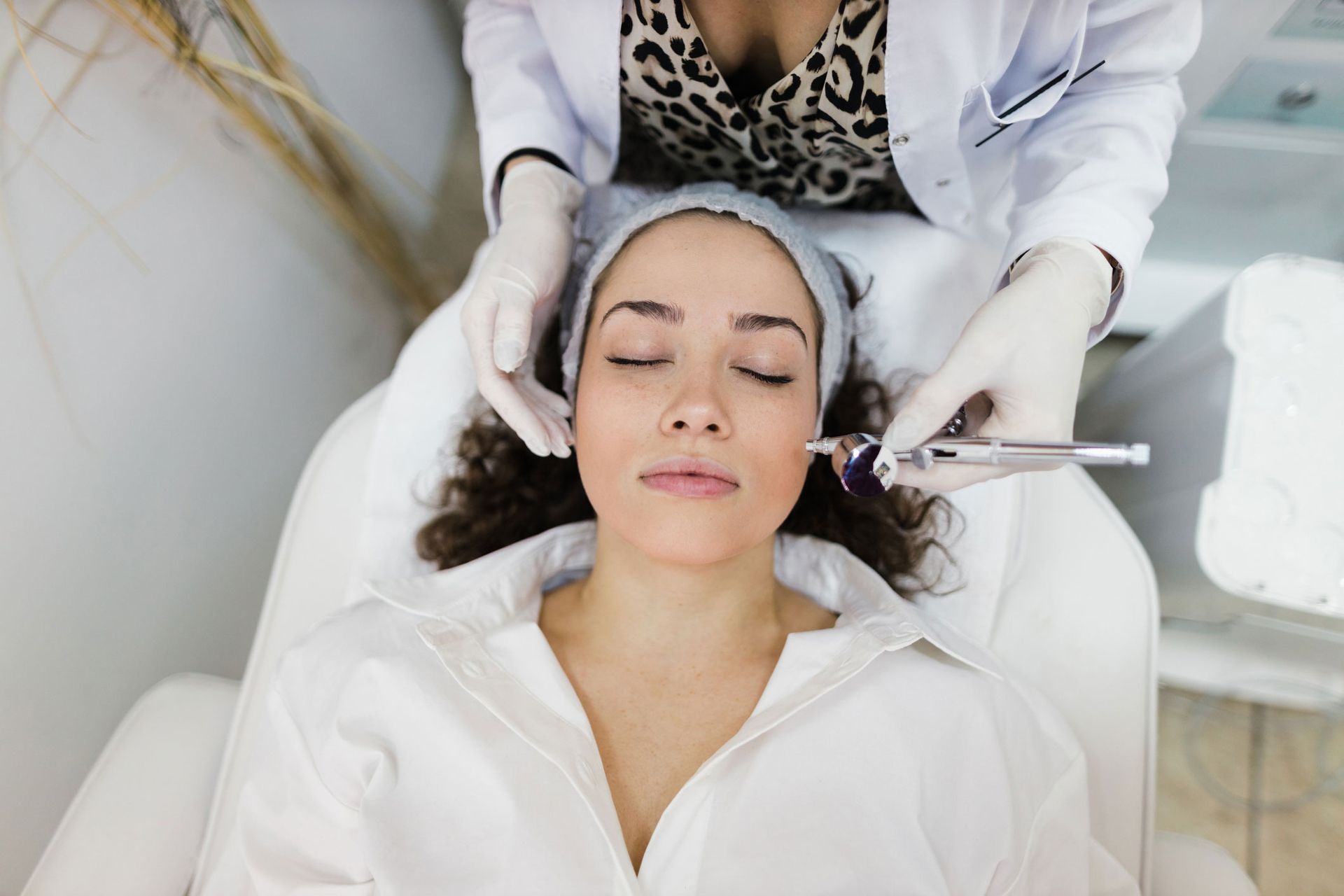A woman is getting a facial treatment at a beauty salon.