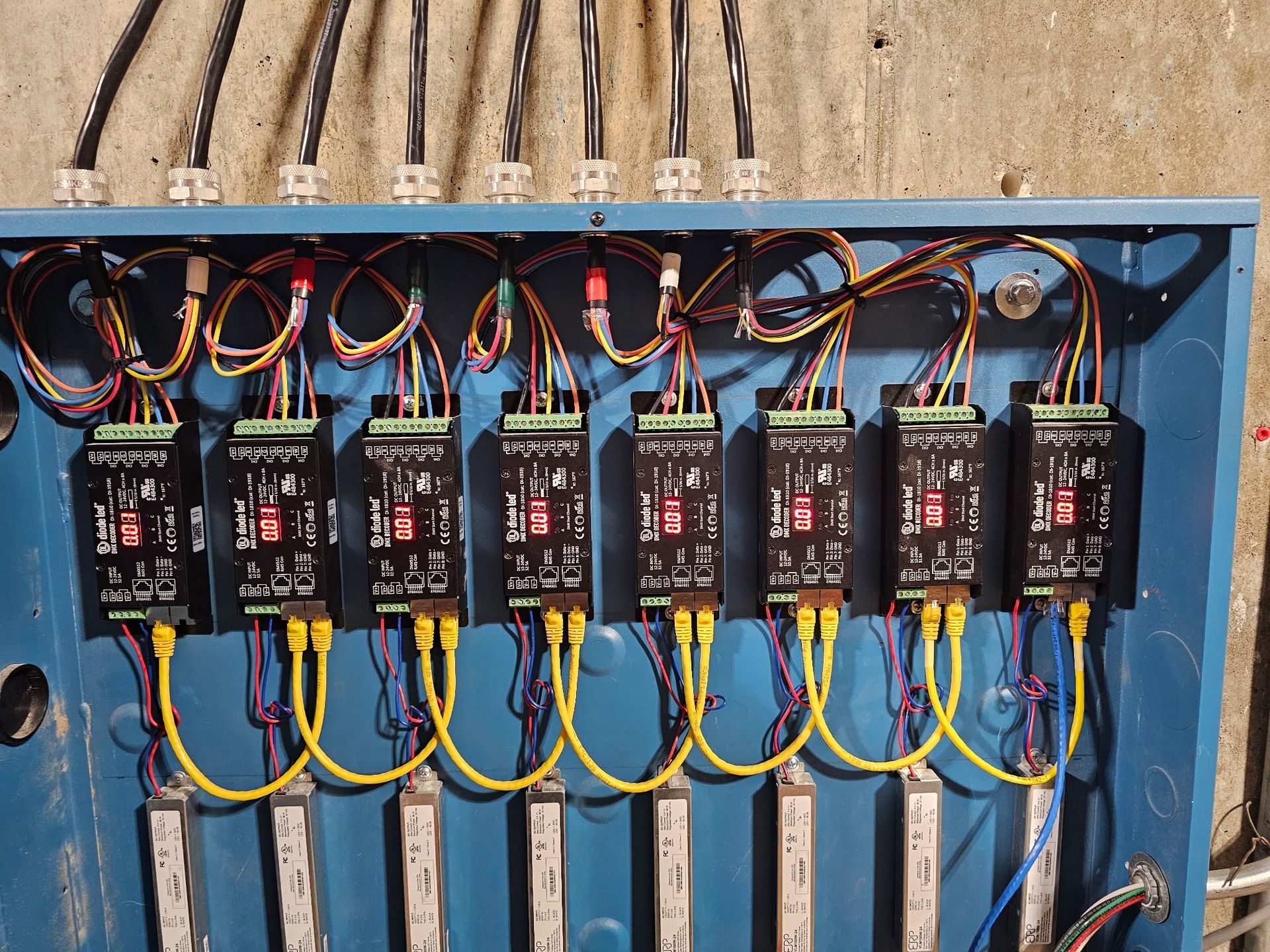 A blue box with a bunch of wires coming out of it