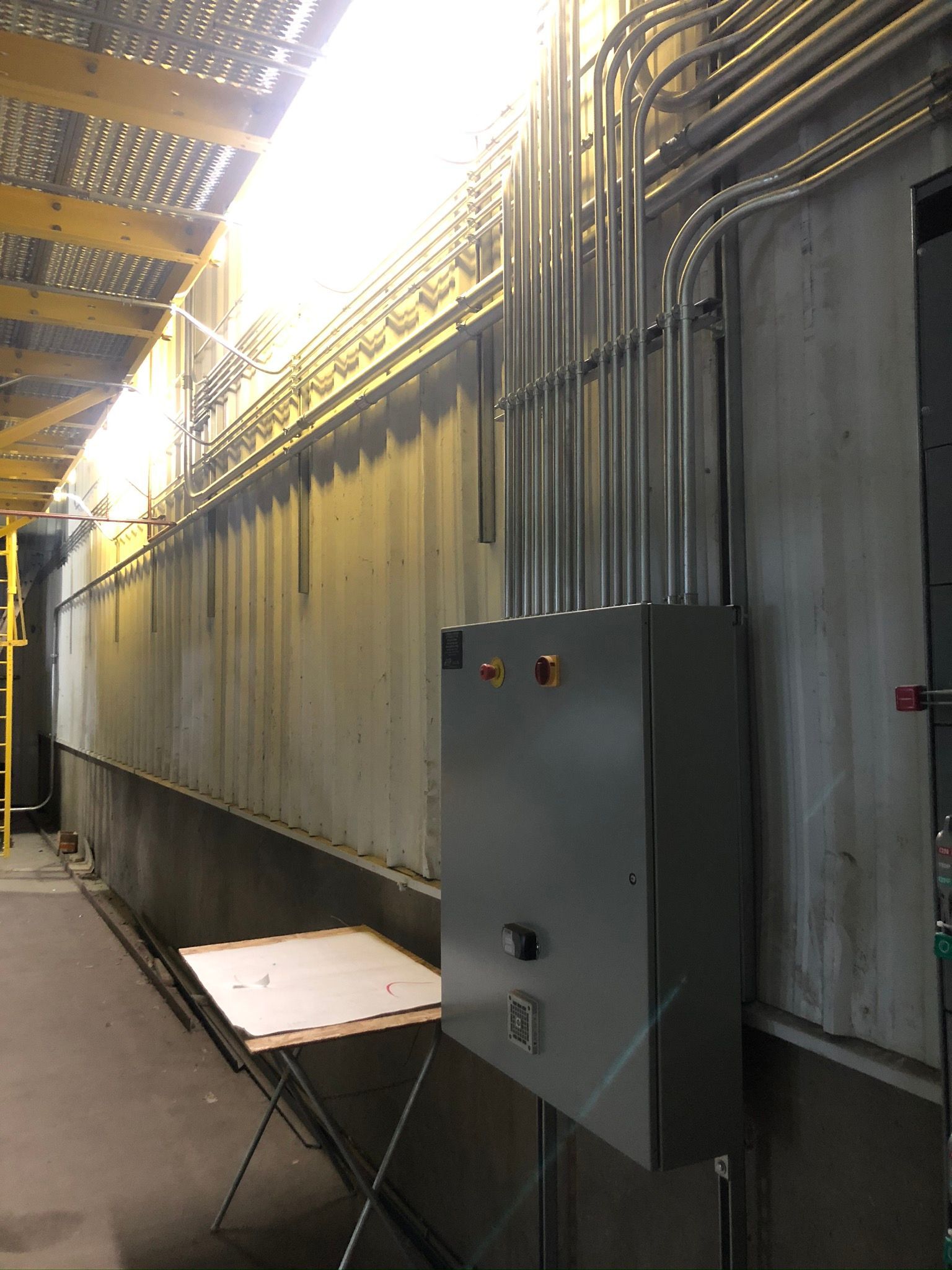 A warehouse with a lot of electrical wires on the wall