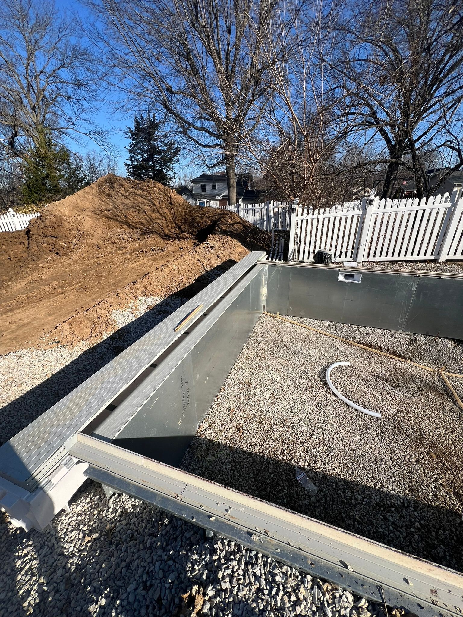 A metal structure is sitting on top of a gravel road.