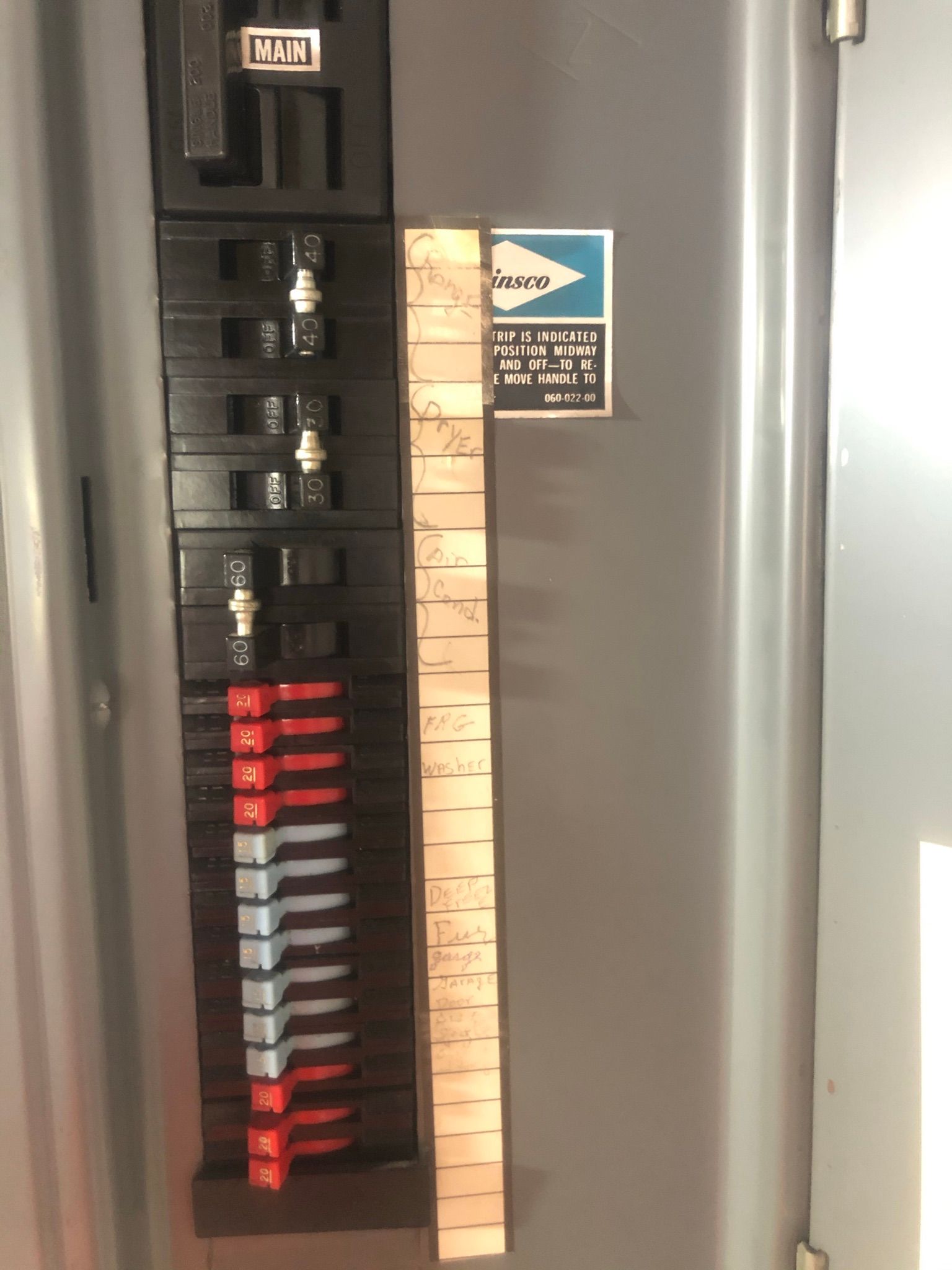 A close up of a electrical panel with a ruler attached to it.