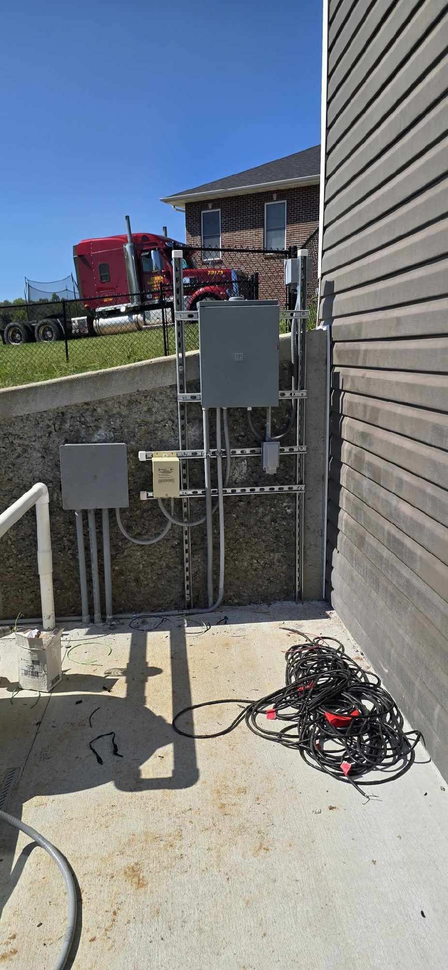 A house with a lot of wires on the side of it.