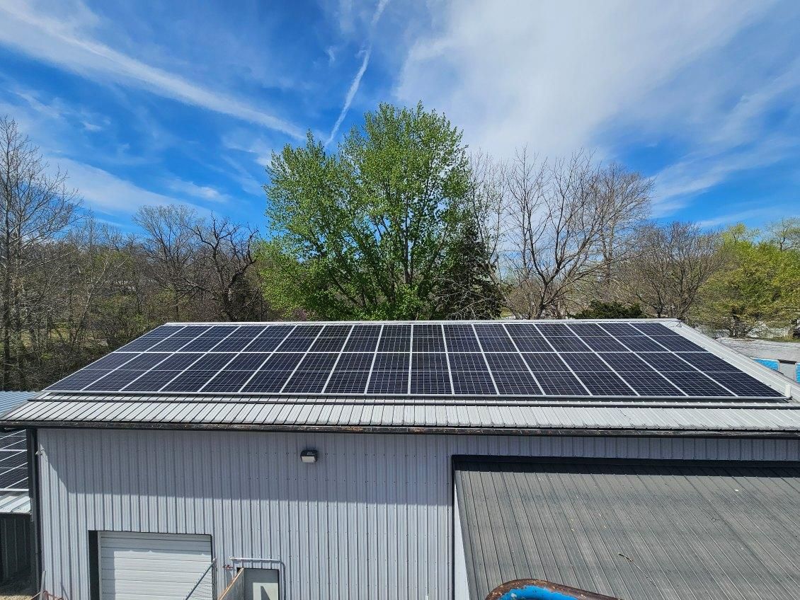 A large building with a lot of solar panels on the roof.