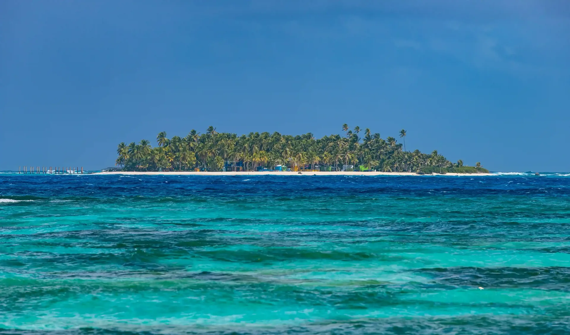 Islote con palmeras rodeado por el mar de los siete colores; lugar donde hacer turismos en San Andrés.