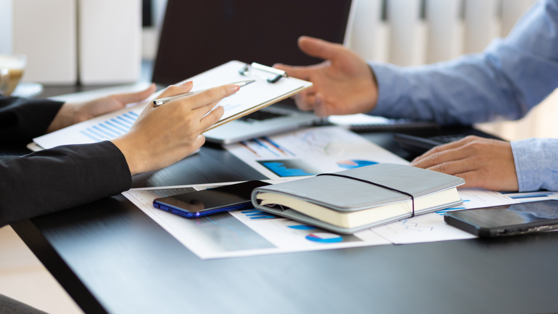 A man in a blue shirt and tie is using a laptop computer.