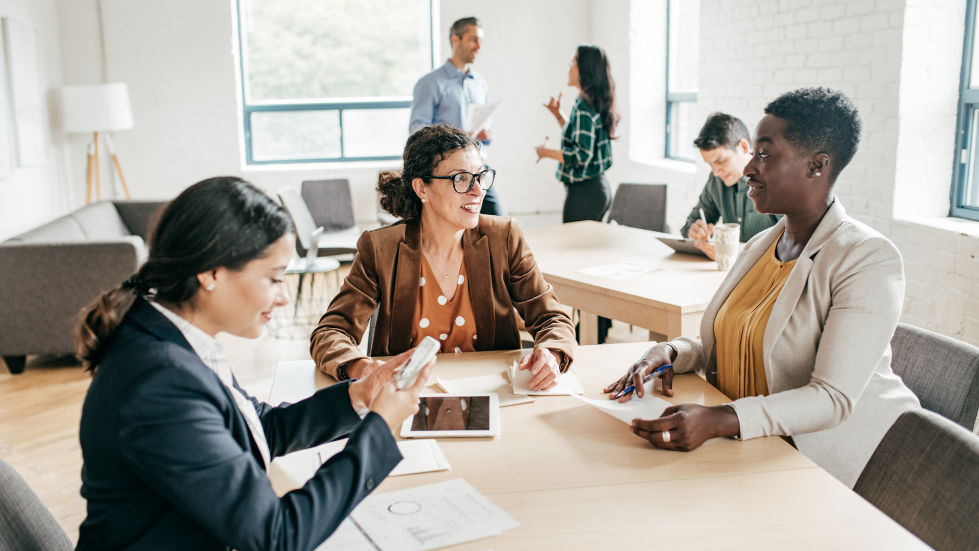 A man in a blue shirt and tie is using a laptop computer.