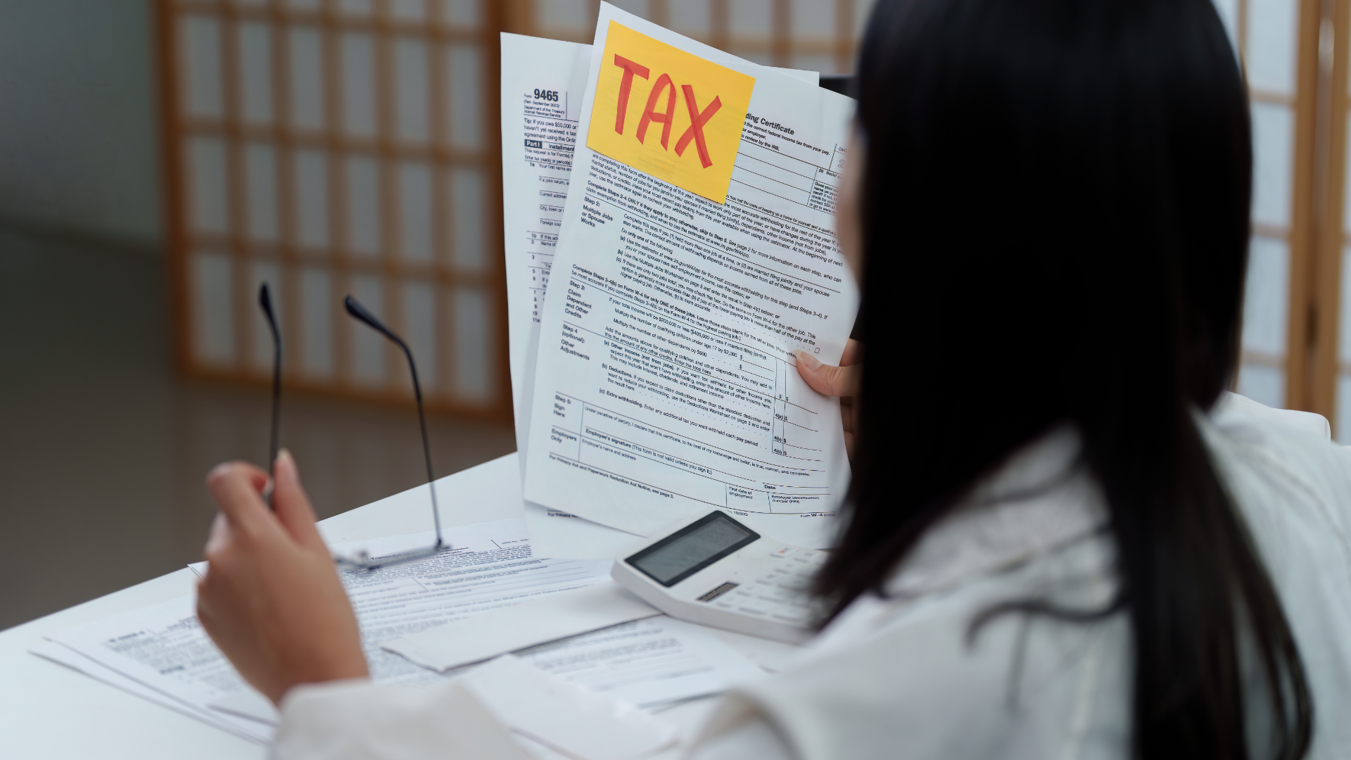 A man in a blue shirt and tie is using a laptop computer.