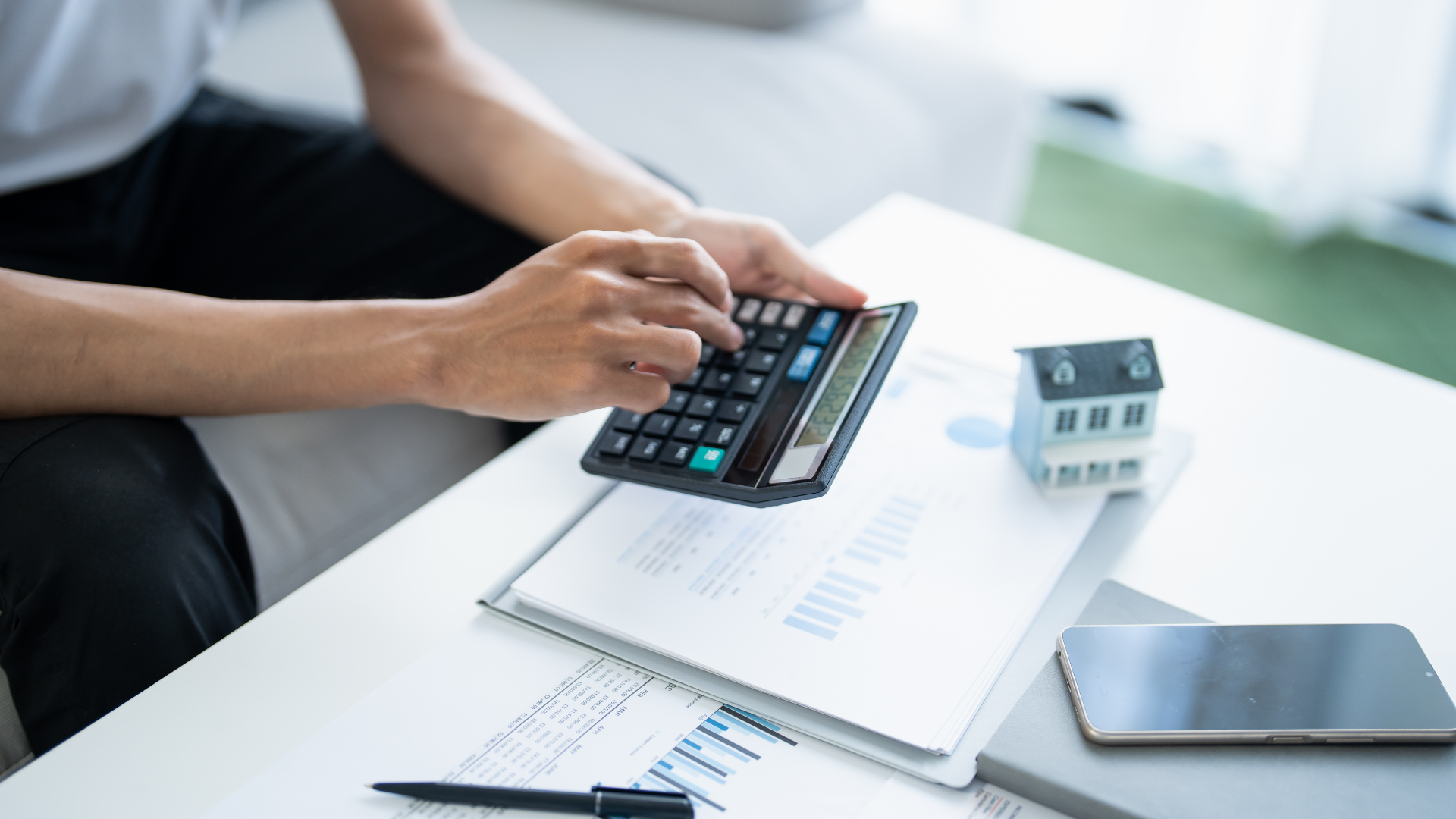 A man in a blue shirt and tie is using a laptop computer.