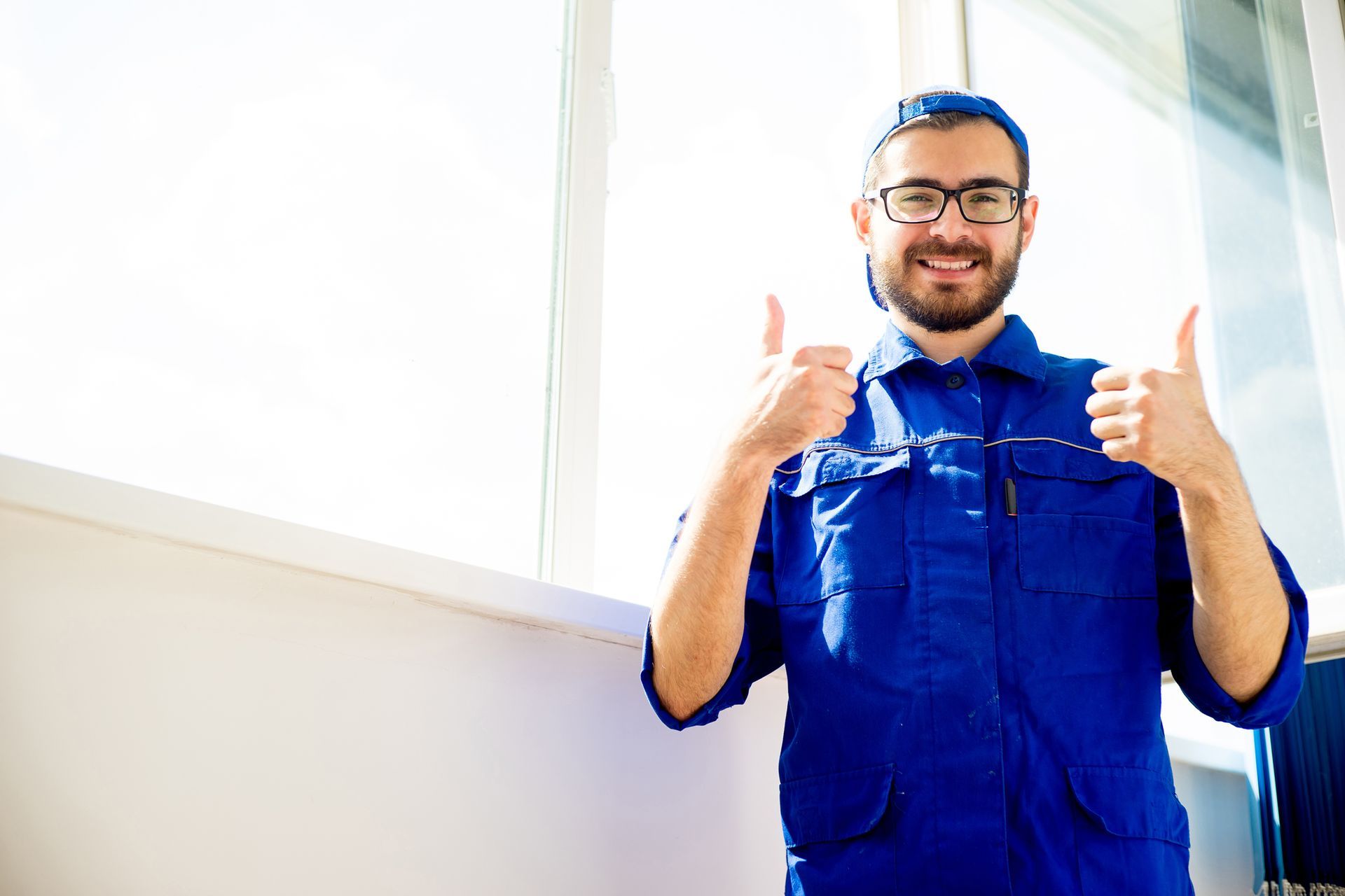 Window replacements expert giving thumbs up after successful installation at home.