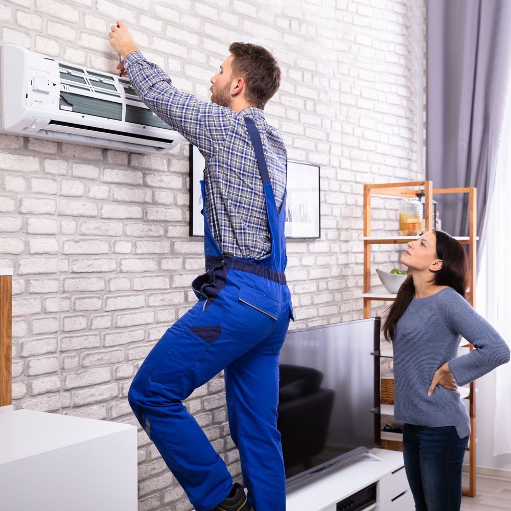 Professional Worker Installing Residential Air Conditioning