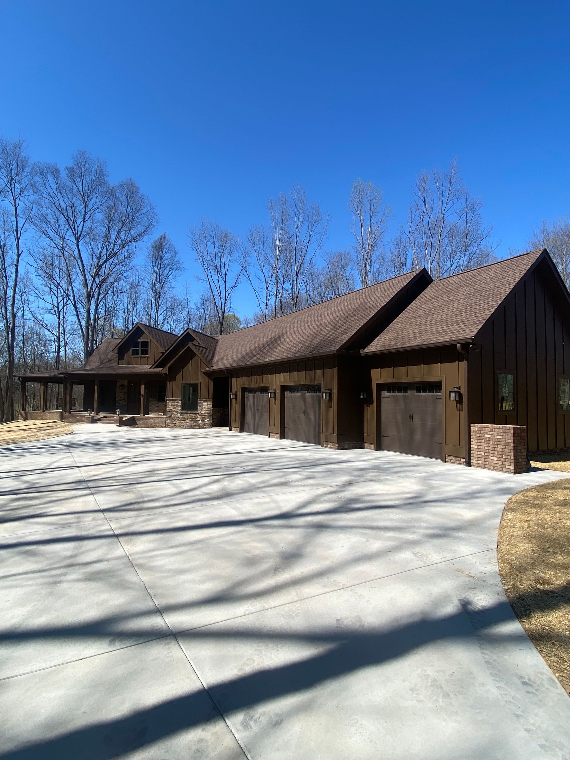 A large house with a lot of garage doors and a driveway