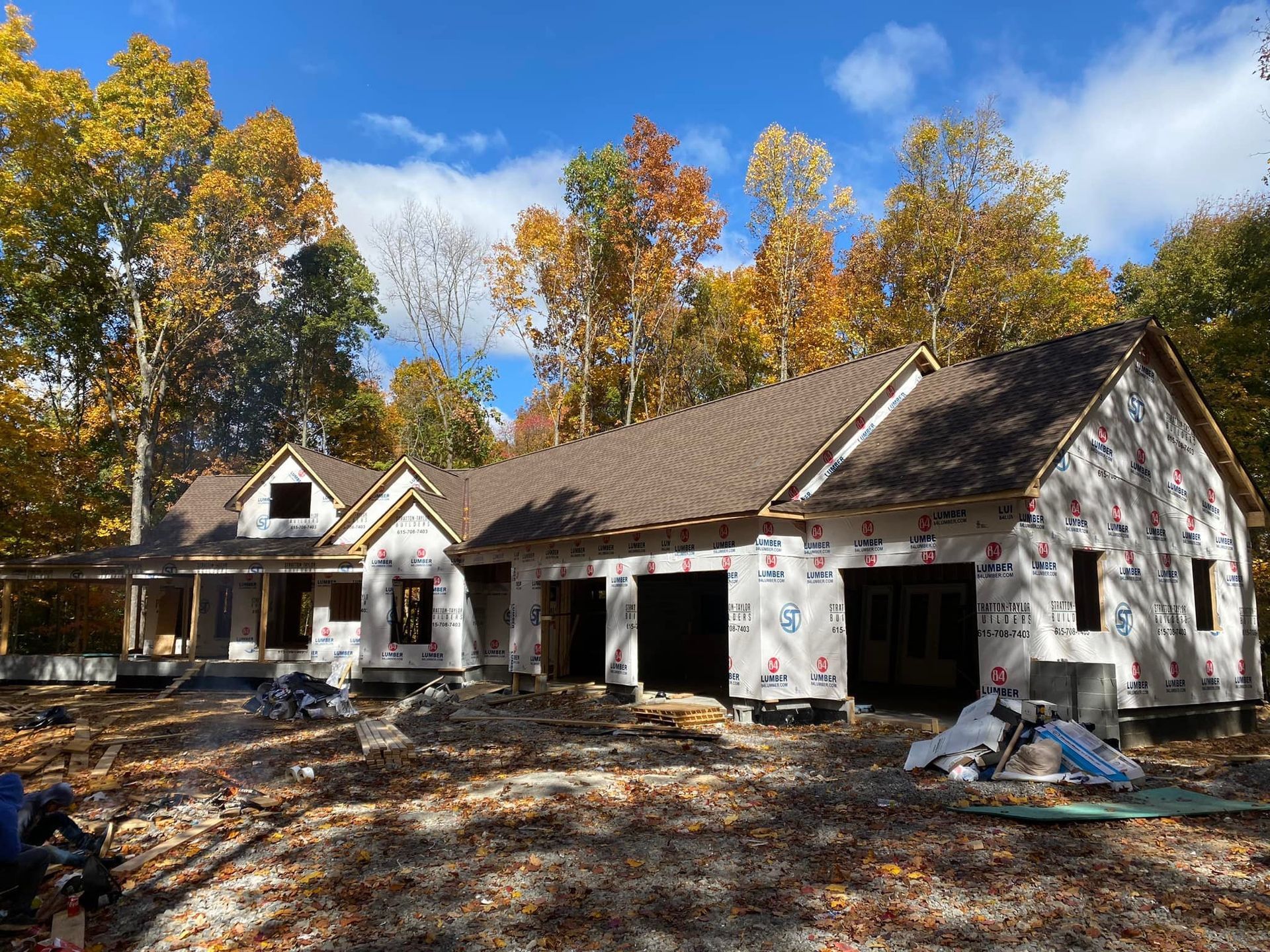 A large house is being built in the middle of a forest.