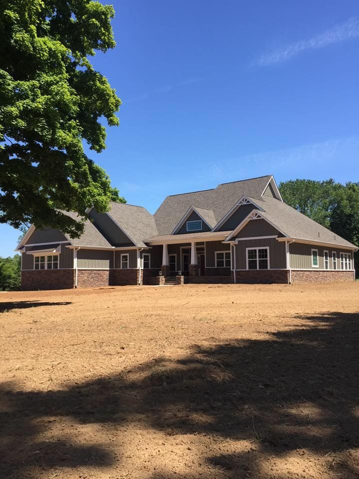 A large house with a tree in front of it