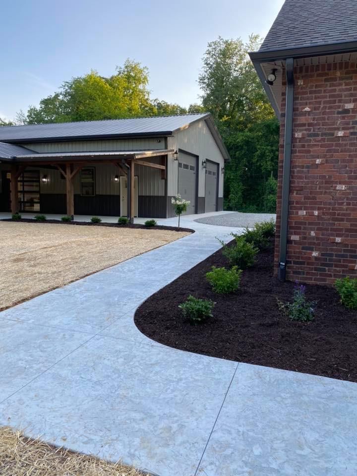 A brick house with a garage and a walkway leading to it