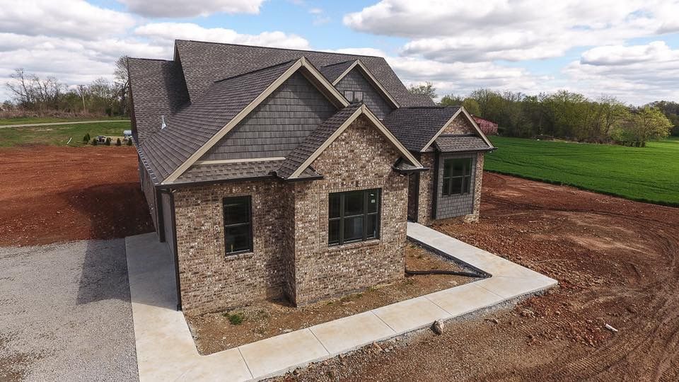 An aerial view of a house that is being built in a field.