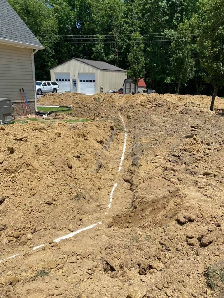 A house is being built in the middle of a dirt field.