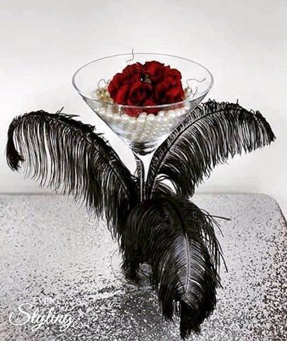 wine glass filled with pearls and red rose