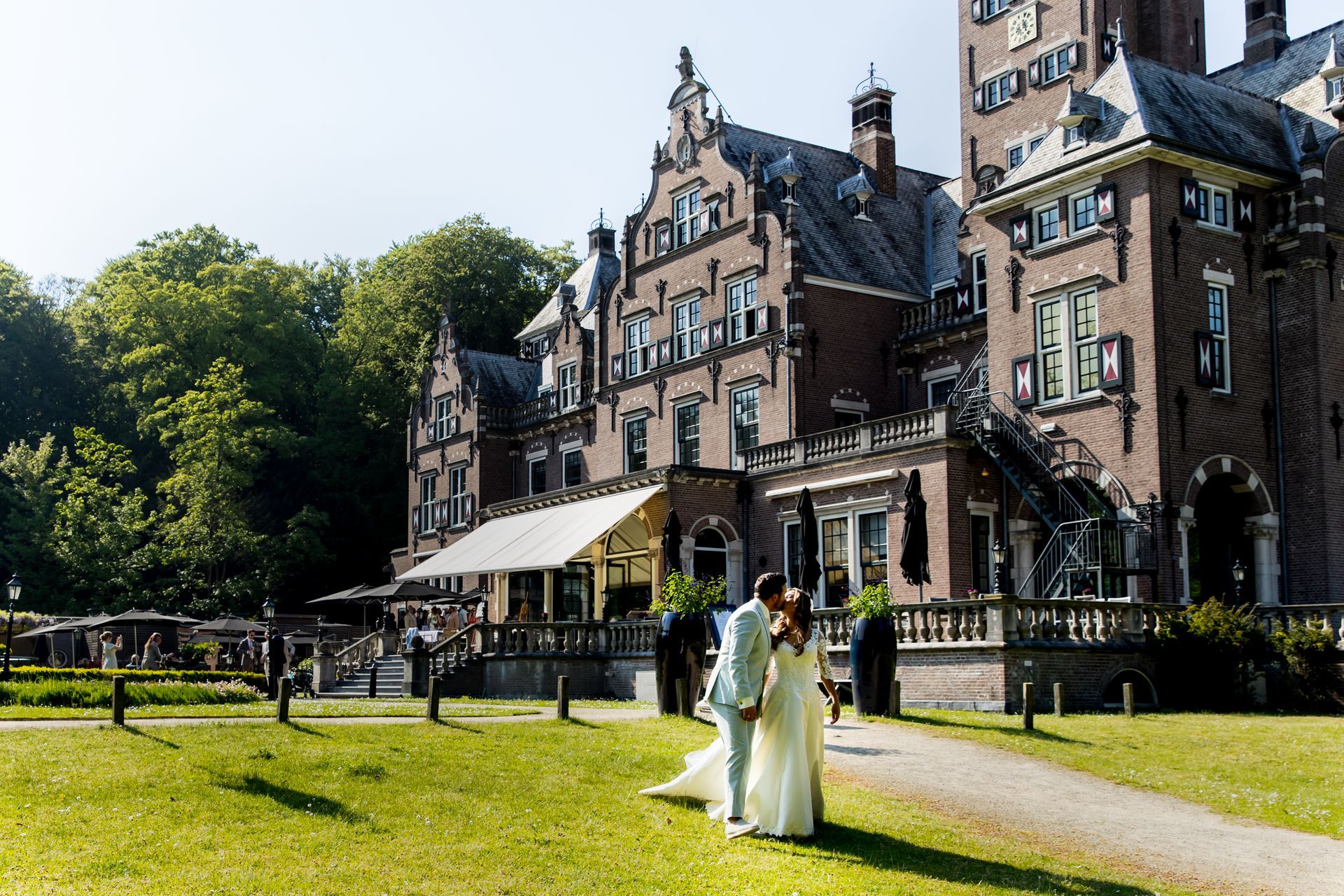 Outside wedding in front of hotel with blue sky and flowers