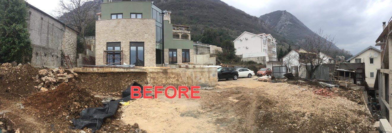 A picture of a house under construction with a mountain in the background.