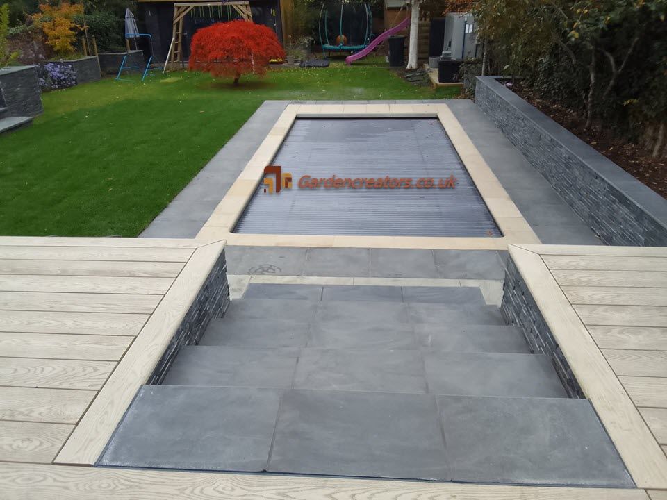 A staircase leading up to a lush green garden