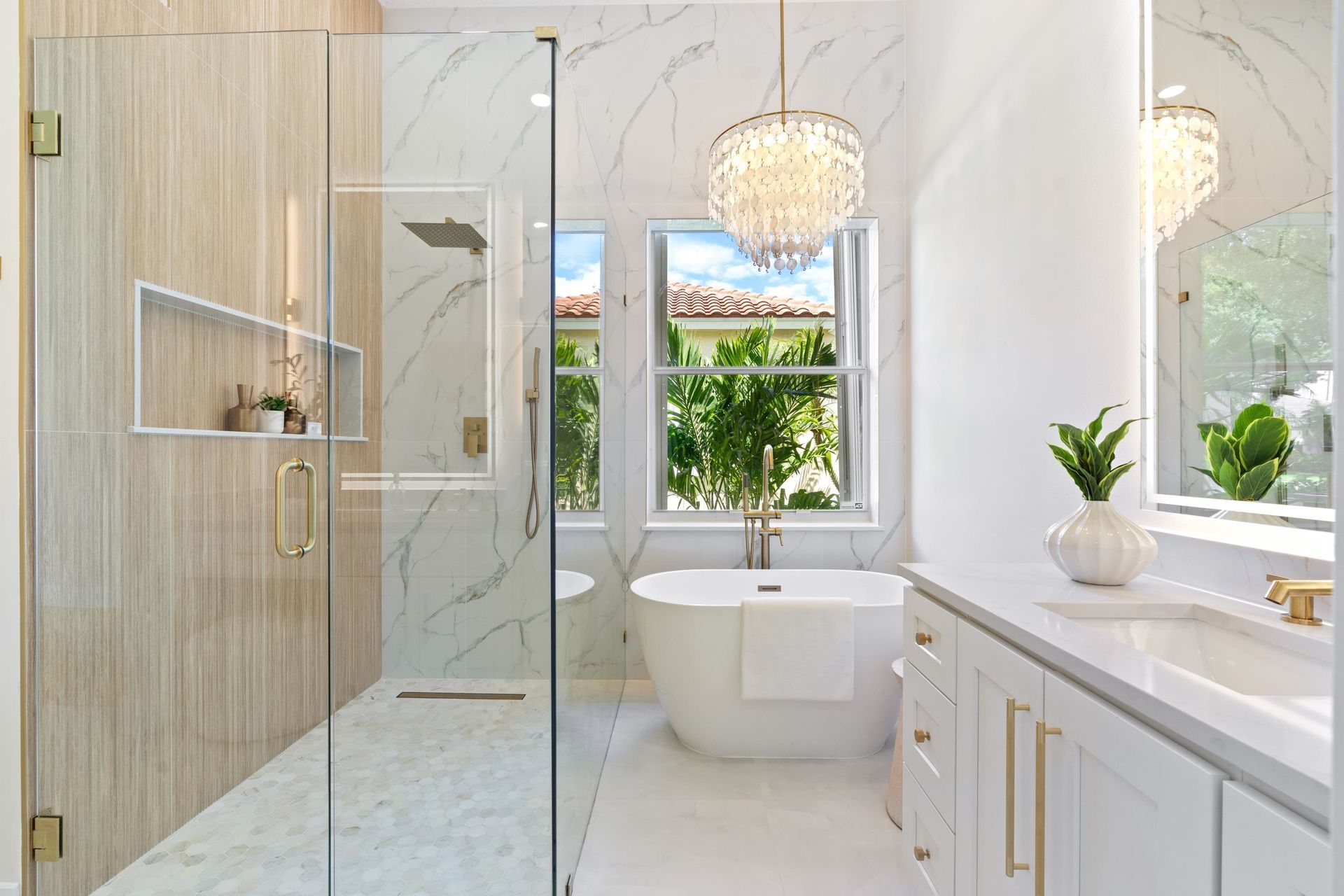 A bathroom with a bathtub , sink , and walk in shower.