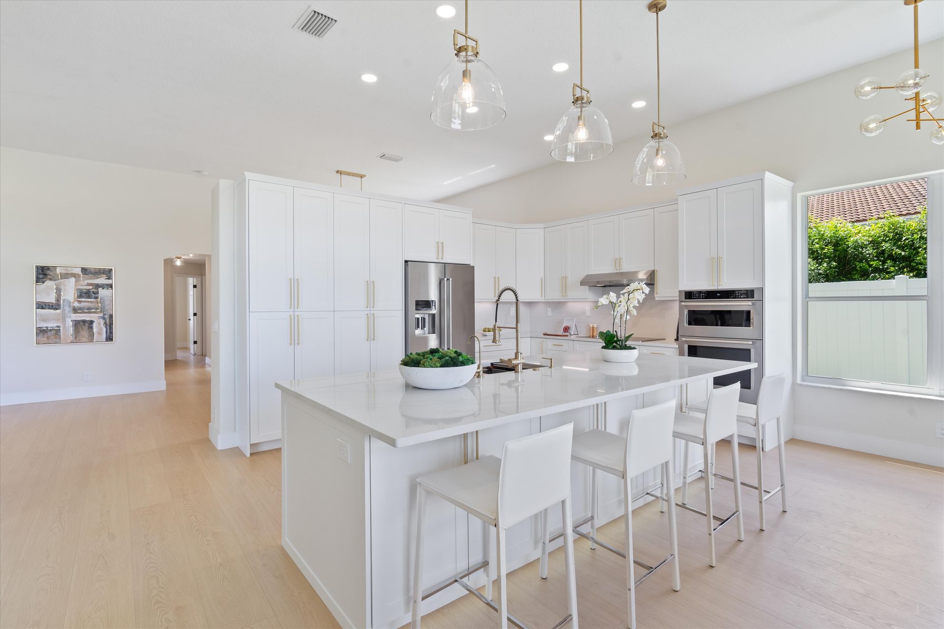 A kitchen with white cabinets and a large island