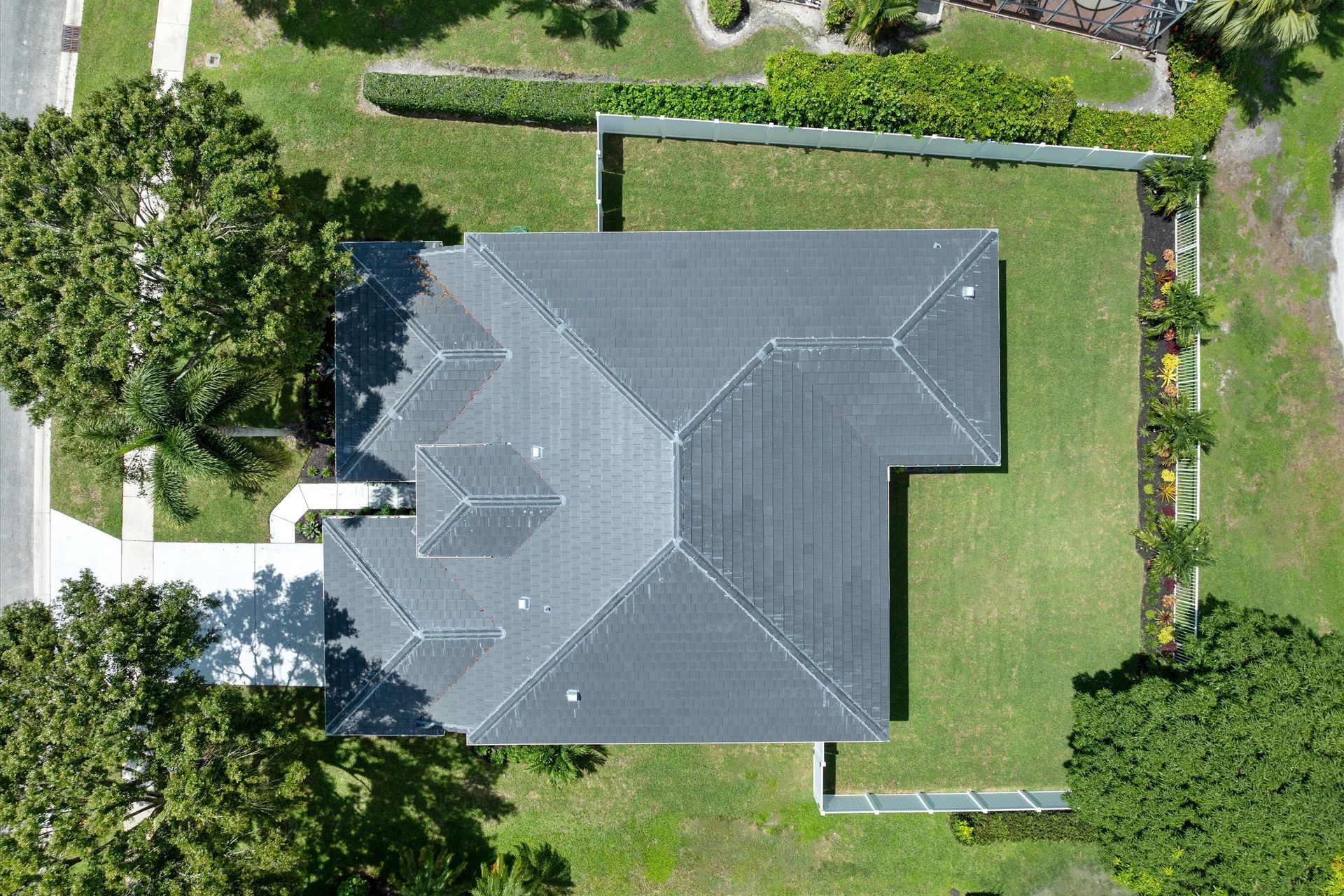 An aerial view of a house with a black roof
