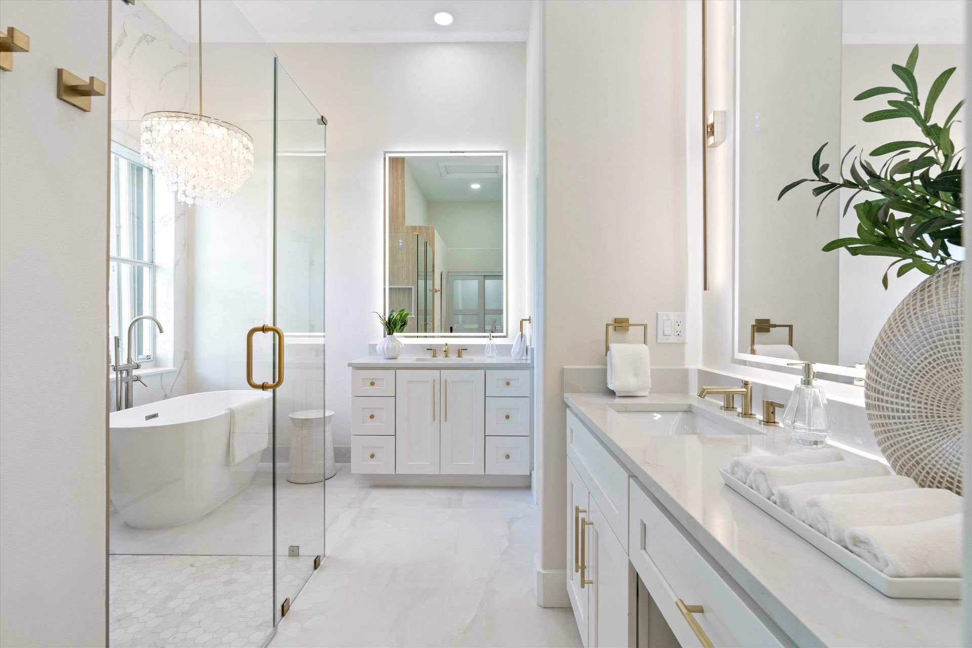 A bathroom with a bathtub , sinks , mirrors and a walk in shower.