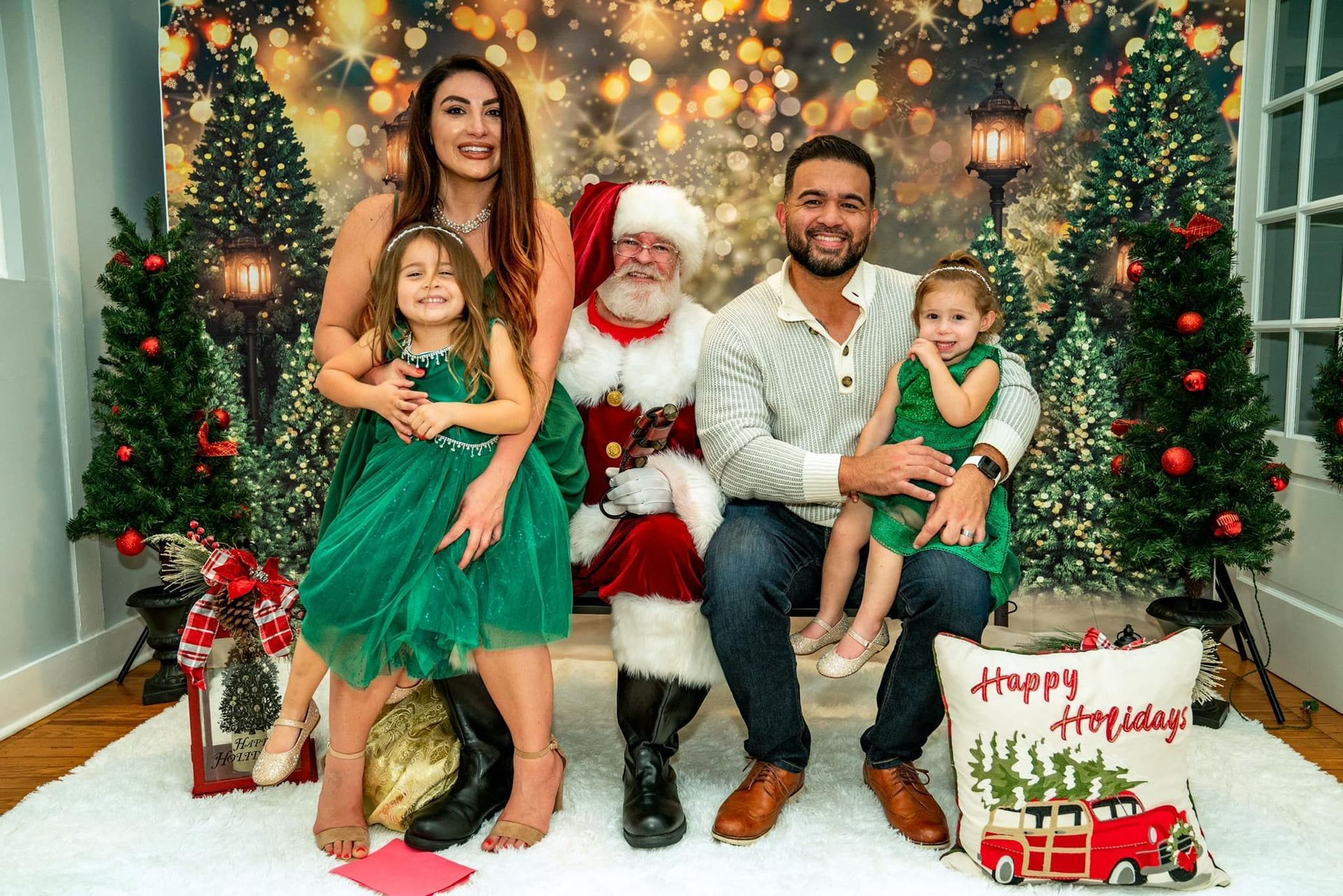 A family is posing for a picture with santa claus.