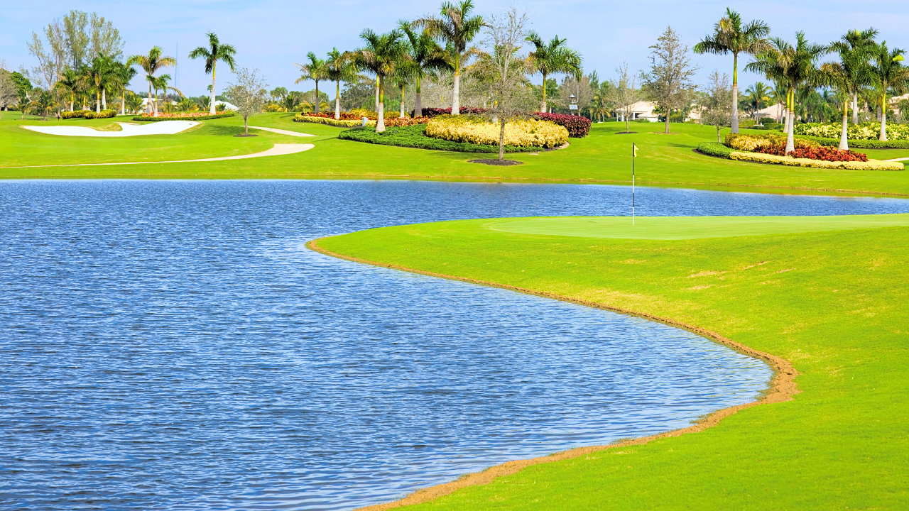 A golf course with a lake in the middle of it