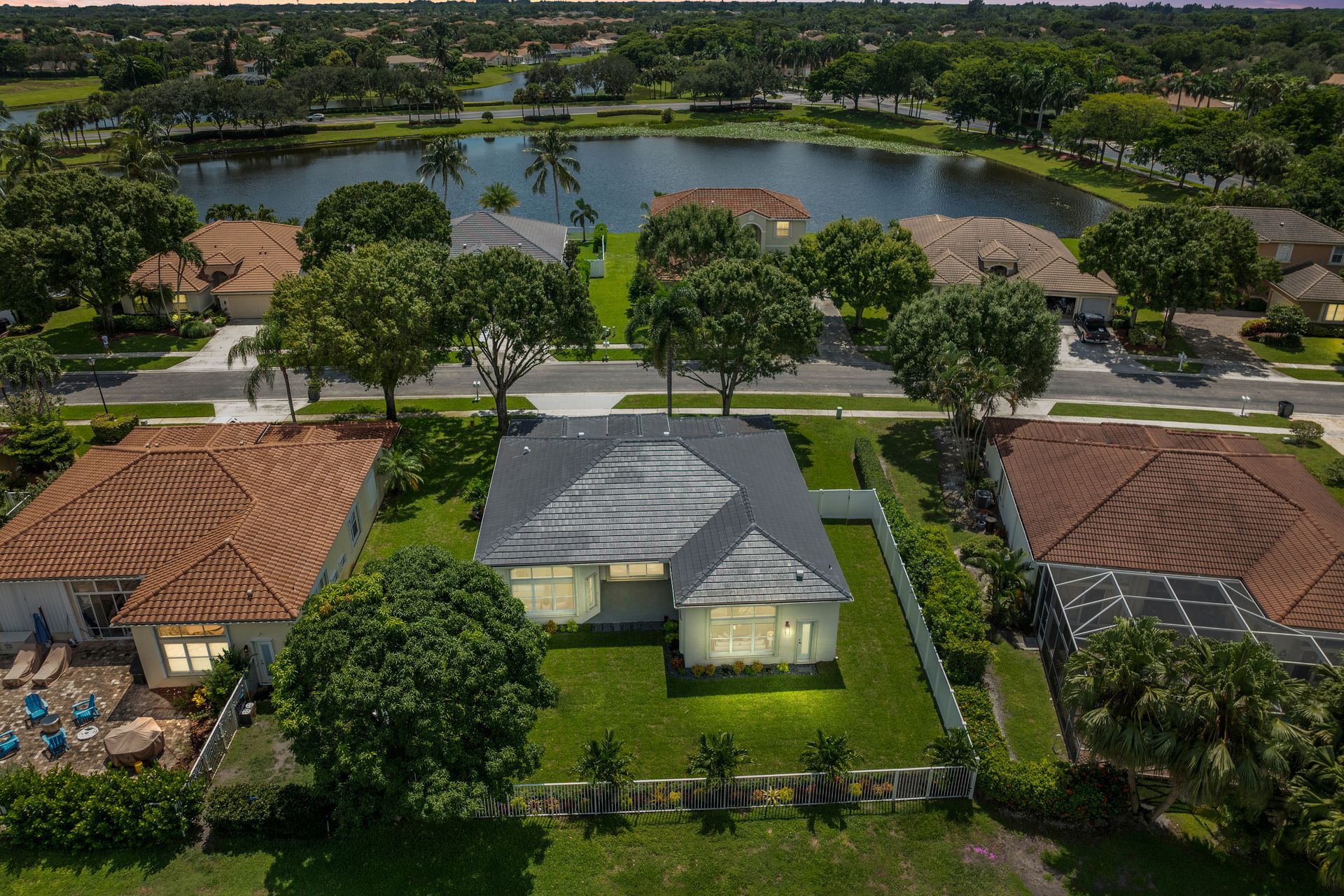 An aerial view of a house with a lake in the background