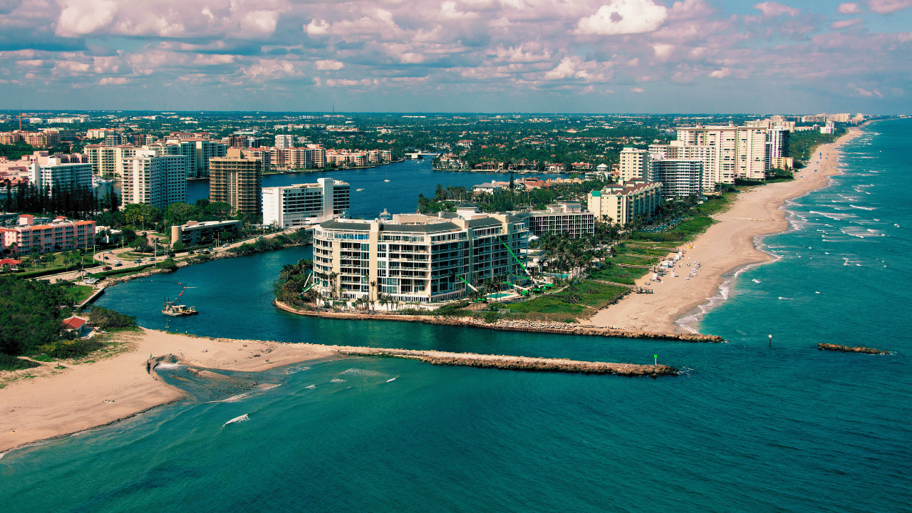 An aerial view of a beach with a city in the background.