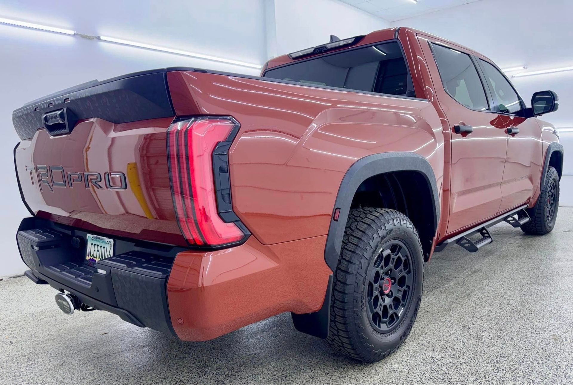 A red truck is parked in a garage.