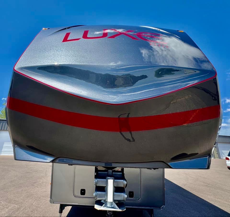 A silver trailer with the word luxe on the front with Bob Moses ceramic coating, Sensha World Crystal Glow